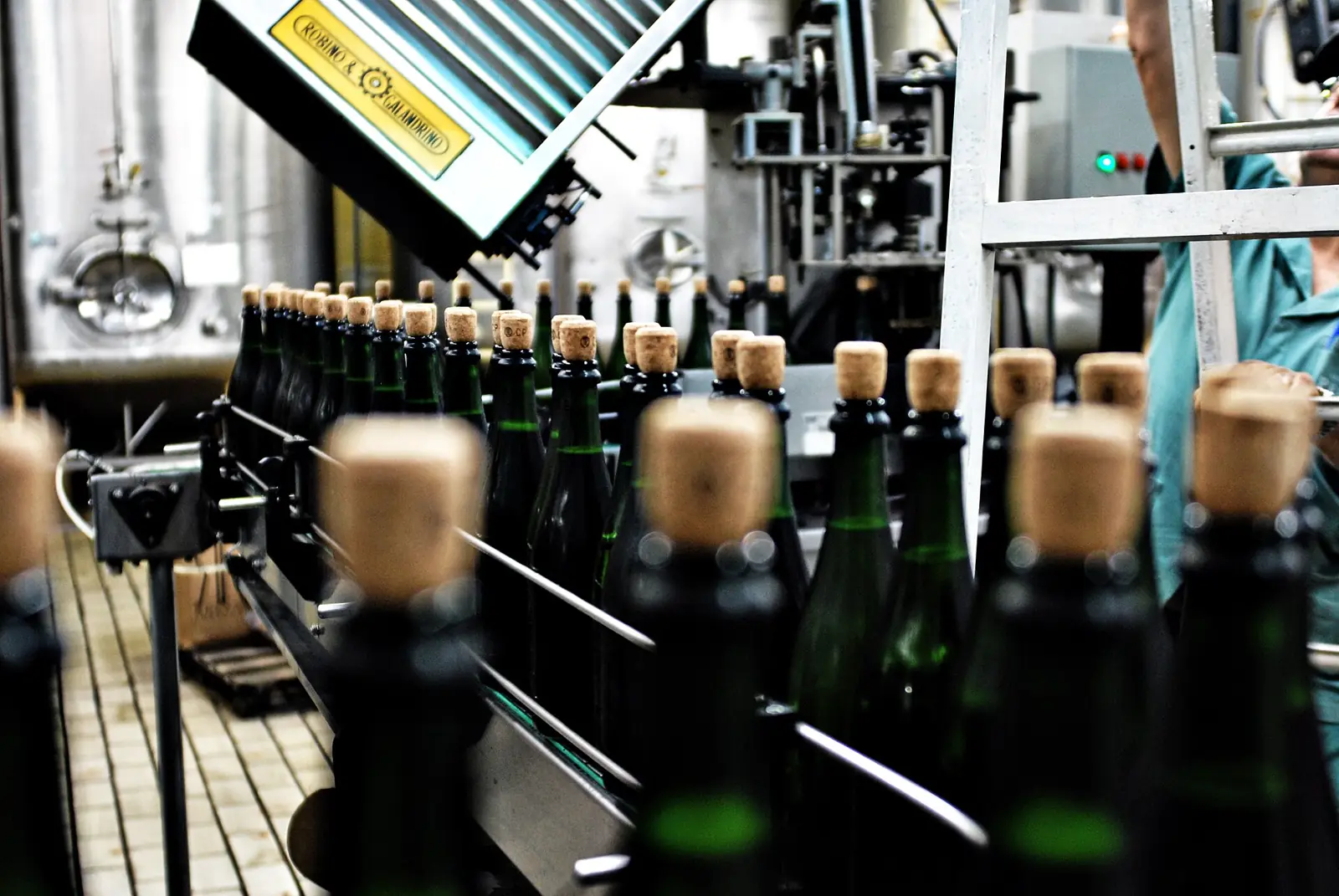 Close view of filled bottles moving through a filling machine