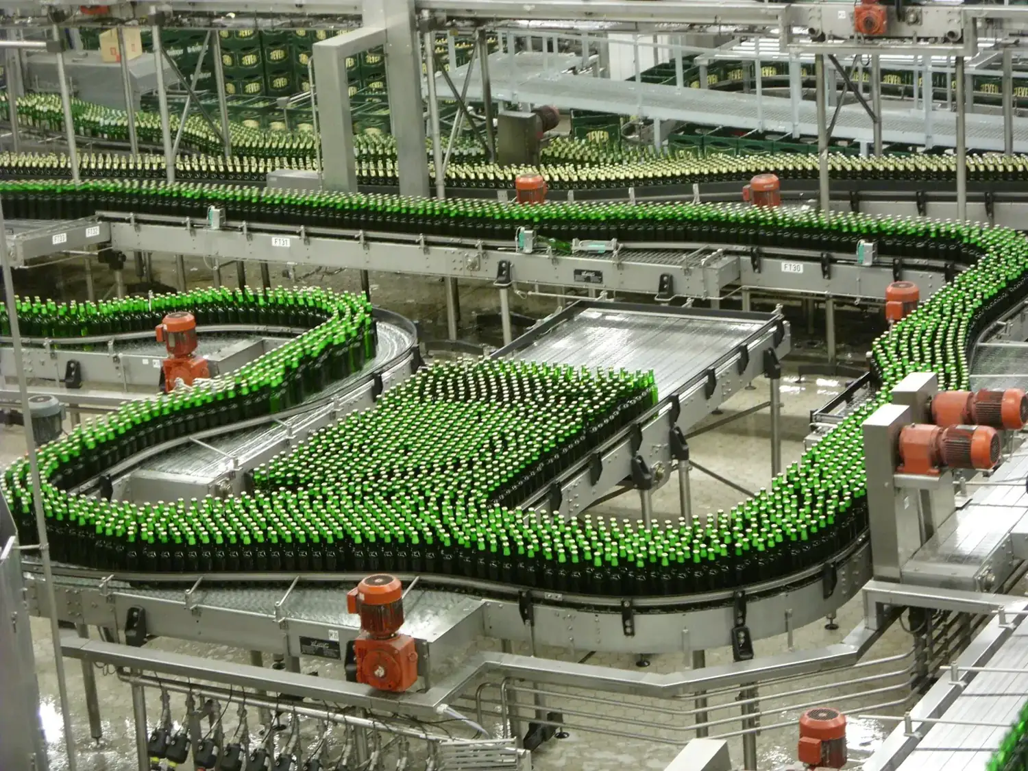 Bottles travelling along a high-speed bottling line conveyor