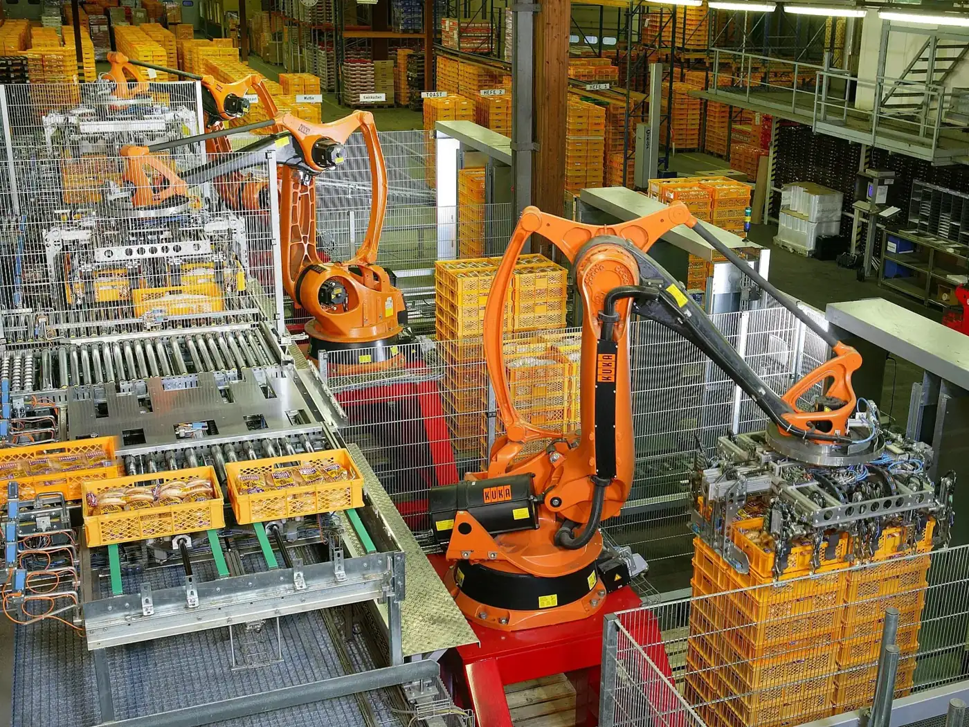 Industrial robots palletising products on an automated production line