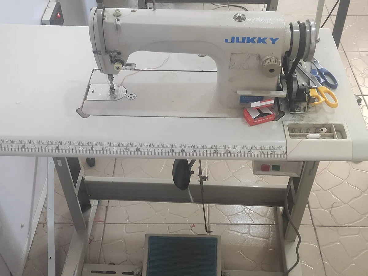 Single needle industrial sewing machine on its table in a workshop